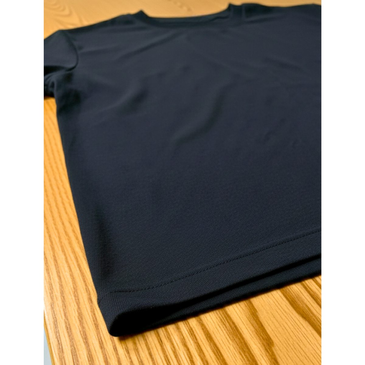 Black t-shirt on a wooden surface