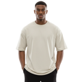 Man wearing an off-white Macbee oversized t-shirt on a white background