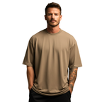 Man wearing a beige Macbee oversized t-shirt on a white background