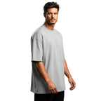 Man wearing a gray Macbee oversized t-shirt on a white background