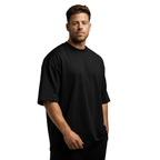 Man wearing a black Macbee oversized t-shirt on a white background