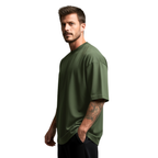 Man wearing a green Macbee oversized t-shirt on a white background