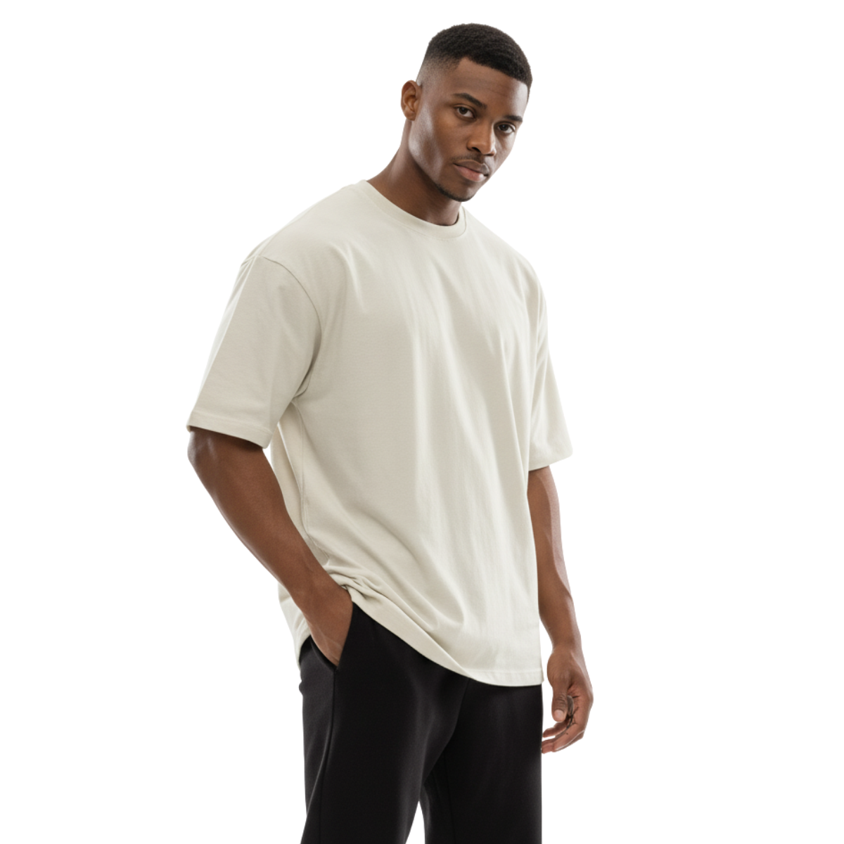 Man wearing an off-white Macbee oversized t-shirt and black pants on a white background