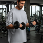 Man lifting dumbbells in a gym setting