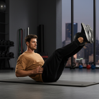 Man exercising on a mat in a gym with cityscape view
