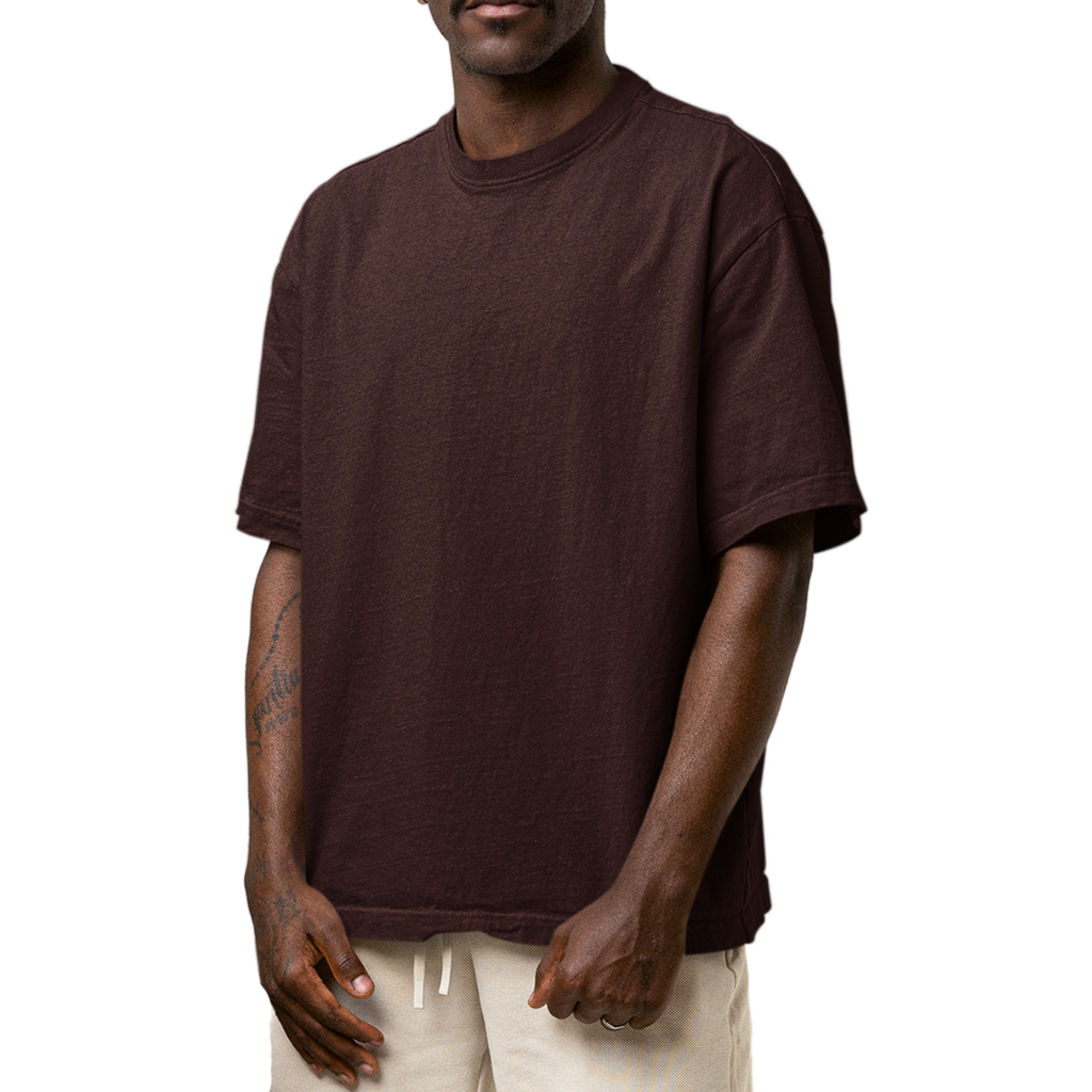 Man wearing a brown Macbee oversized t-shirt on a white background