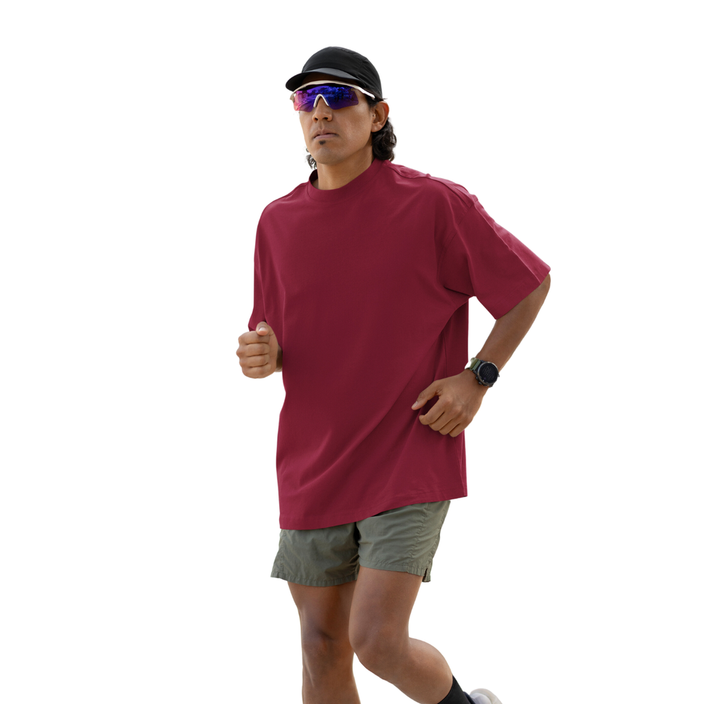 Person wearing a marsala Macbee oversized shirt and sunglasses on a white background