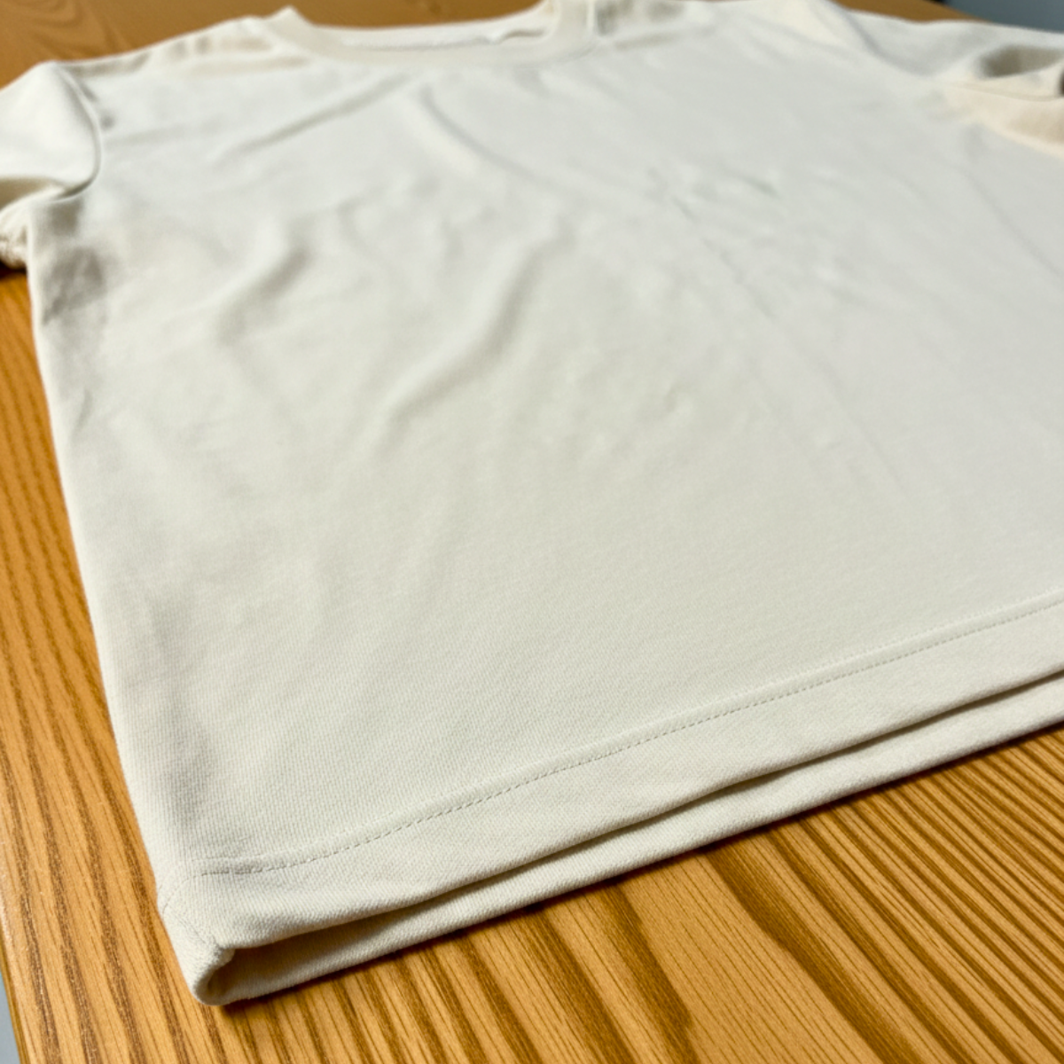 White t-shirt on a wooden surface